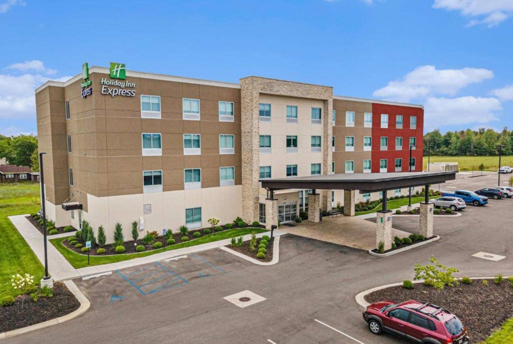 Holiday Inn Express South Haven – IHG hotel exterior with modern four-story design and parking area.