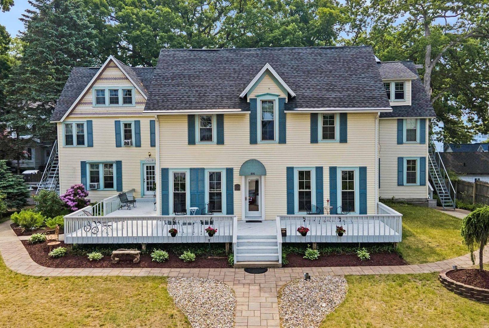 Historic Waters View Inn in South Haven with wraparound porch and classic coastal-style architecture.