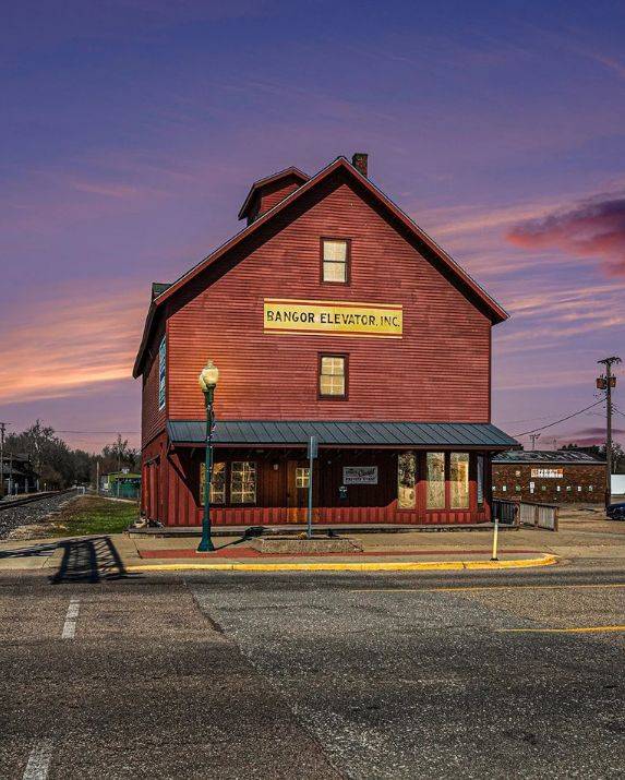 About Mill Hall. Mill Hall wedding and event venue in Bangor, Michigan, historic red grain elevator building at sunset