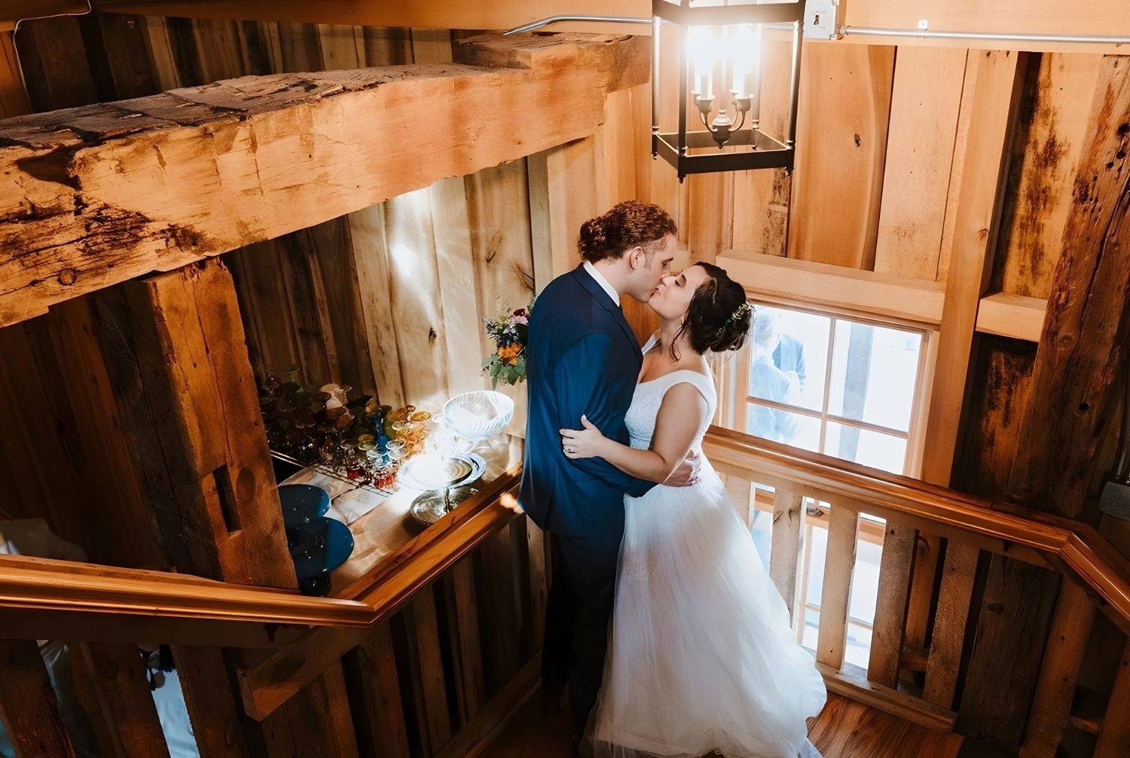 Mill Hall wedding venue featuring a couple sharing a kiss inside a historic grain mill wedding venue in Michigan