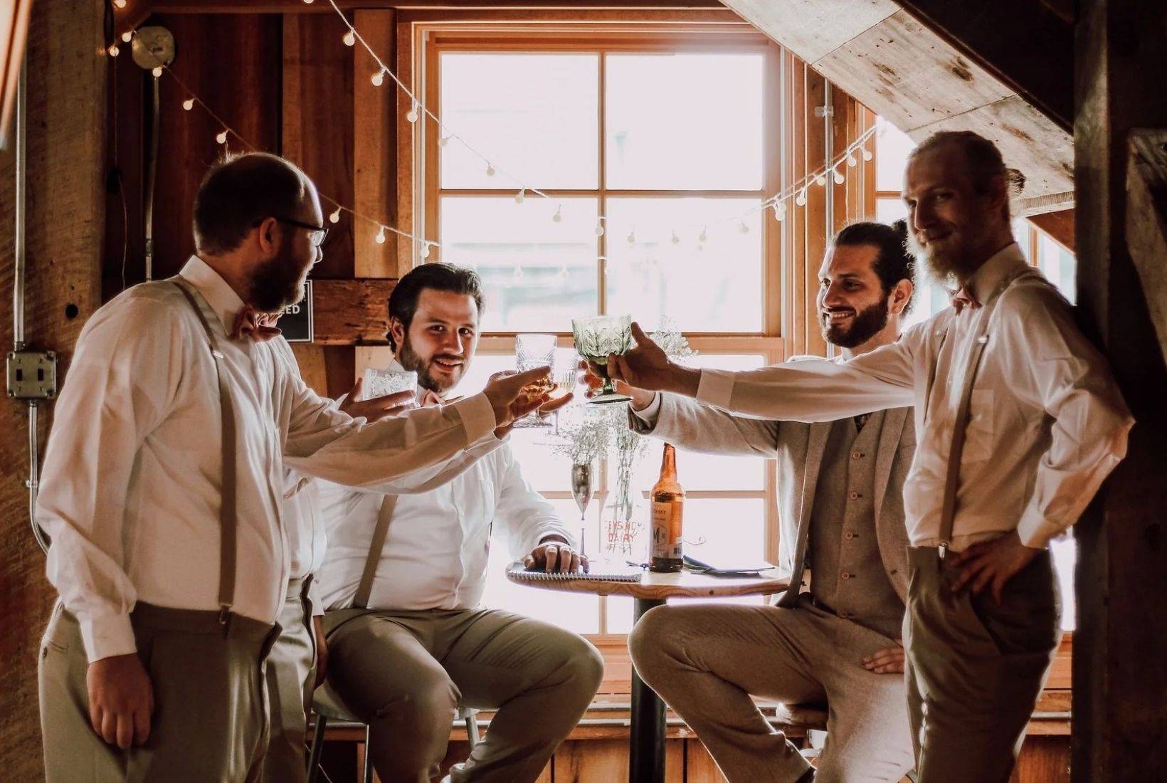 Mill Hall wedding venue groomsmen celebrating inside a historic grain mill wedding venue in Michigan